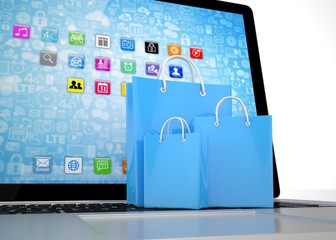 laptop and  shopping pags on white background