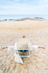 Young woman relaxing on a beautiful beach.