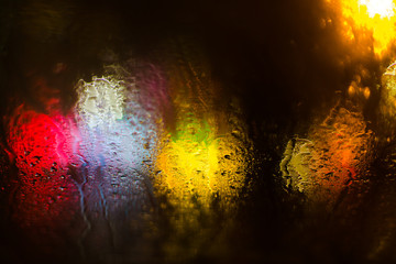 Colorful defocused bokeh lights background. City glare abstract background.