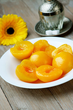 Peaches on the dish, gerber and sugar-bowl