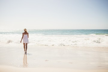 Blonde woman close to water at the beach