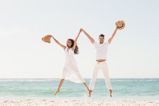 Smiling couple jumping together