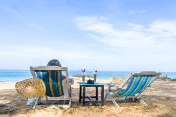 Girl on a tropical beach with hat