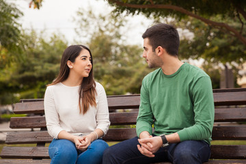 Young couple talking at a park © AntonioDiaz