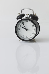 Alarm clock on white background, minimalism