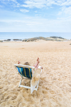 Young woman relaxing on a beautiful beach.