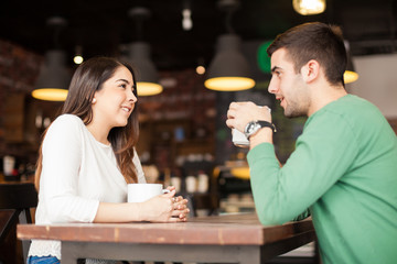 Cute couple drinking coffee at a restaurant