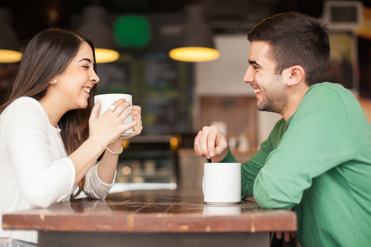 Young couple having fun at a cafe