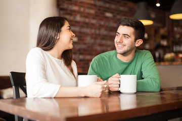 Young couple dating and drinking coffee