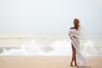 Fototapeta na wymiar Woman with sarong on the beach