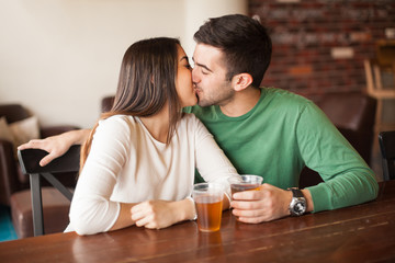 Young couple kissing at a bar