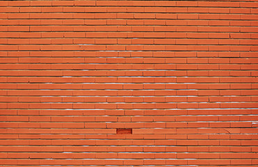 Orange brick wall background with a missing brick