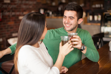 Young couple making a toast with beer