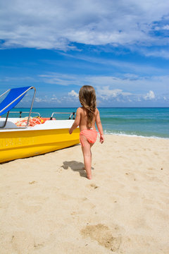 Little girl playing at the beach