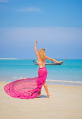  Beautiful woman in bikini and sarong enjoying perfect sunny day