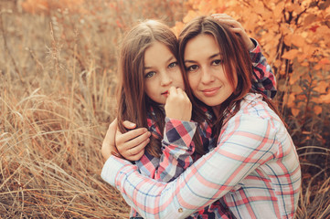 happy mother and daughter on the walk on summer field. Family spending vacation outdoor, lifestyle capture., cozy mood