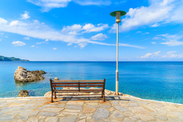 Bench on coastal promenade along Kokkari beach, Samos island, Greece © pkazmierczak