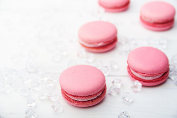 Sweet pink macaroons on wooden table