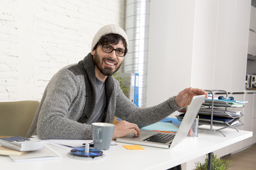 corporate portrait young hispanic attractive hipster businessman working with computer modern home office