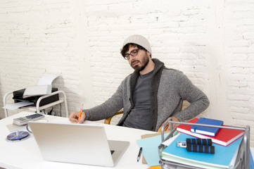 corporate portrait young hispanic attractive hipster businessman working with computer modern home office