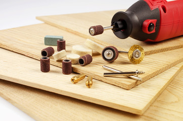 Engraving machine and accessories are on the thin oak the boards