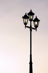Fototapeta na wymiar Old street lamppost against twilight background