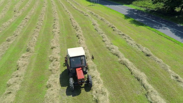 Retro tractor is hay harvesting