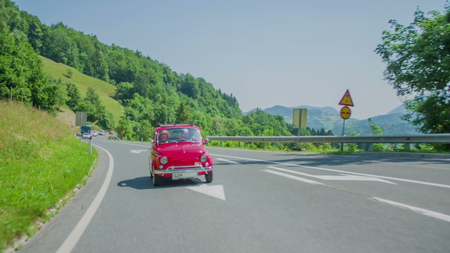 Red zastava car passing the bus stop and cross roads