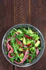 Salad with arugula, salami and avocado