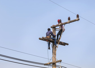 electricians working on electric power pole