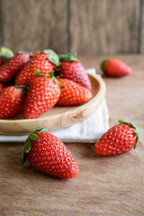 Fresh strawberries on rustic wooden table