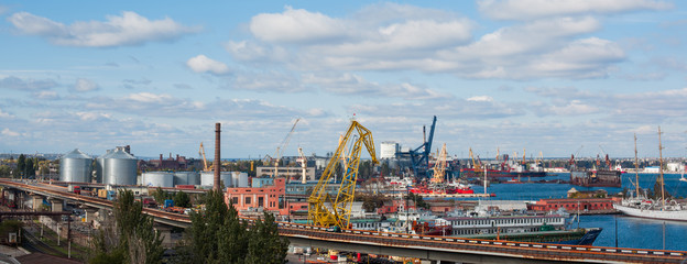view of the port, cranes and containers and loading cargo ship