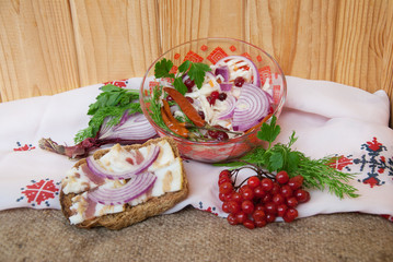 Bowl with cabbage salad and lard sandwich with whole wheat bread