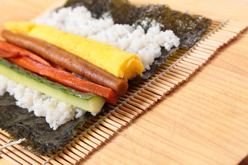 Preparing sushi on sushi mat