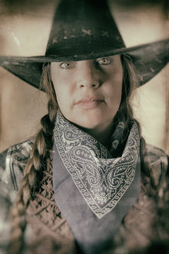 Old West Cowgirl Eyes. Old west cowgirl looks into camera, edited in vintage film style.