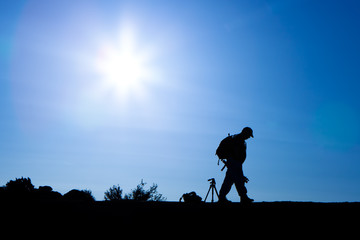 Silhouette of Photographer With Backpack in Morning