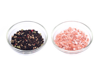 Himalayan pink salt and rainbow peppercorns on white background