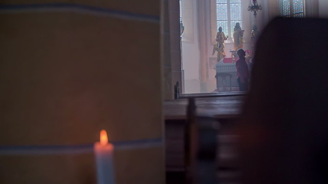 A couple is standing by the altar in church