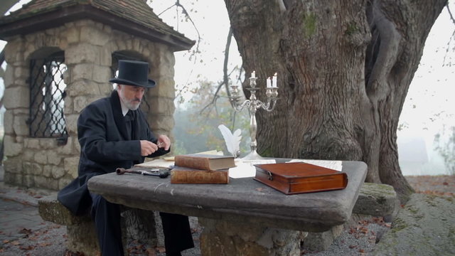 Educated man thinking at the garden table