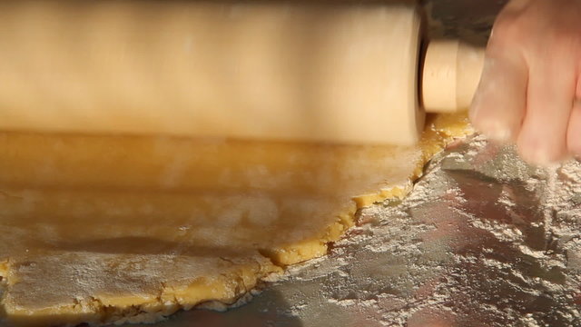 Baking Sugar Cookies 10. Preparing, mixing, baking and decorating Christmas sugar cookies. Flattening cookie dough with a rolling pin.