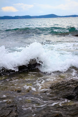 Water splashing. Crystal clear sea water beating against the roc