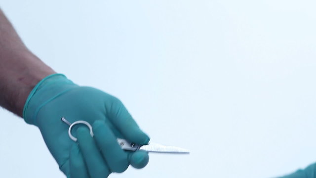 Surgical instrument is passed to surgeons hand