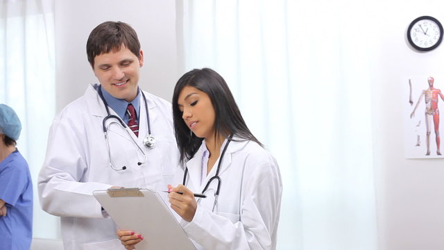 Doctor and nurse looking at clipboard