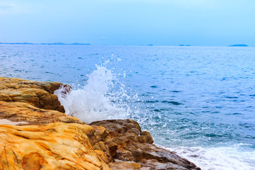 Water splashing. Crystal clear sea water beating against the roc
