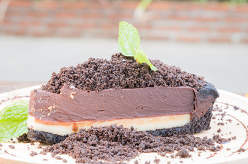 chocolate cheesecake with chocolate glaze on dish wood,selective focus