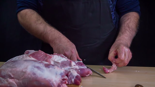 Cutting extra fat off raw meat