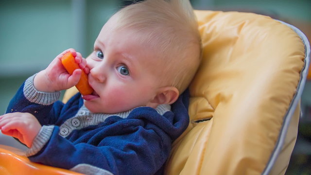 Happy child eating a caret 