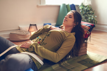 Attractive mixed race woman doing restorative yoga