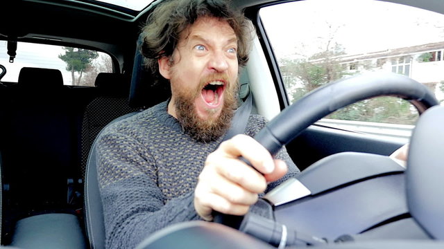 Man screaming scared of getting into accident while driving car slow motion