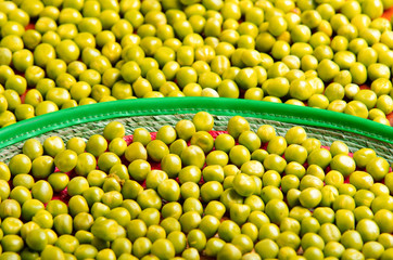 Nice display of many green lima beans. delicate layout over wooden surface